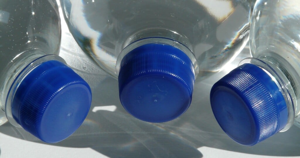 Blue caps on full bottles of water