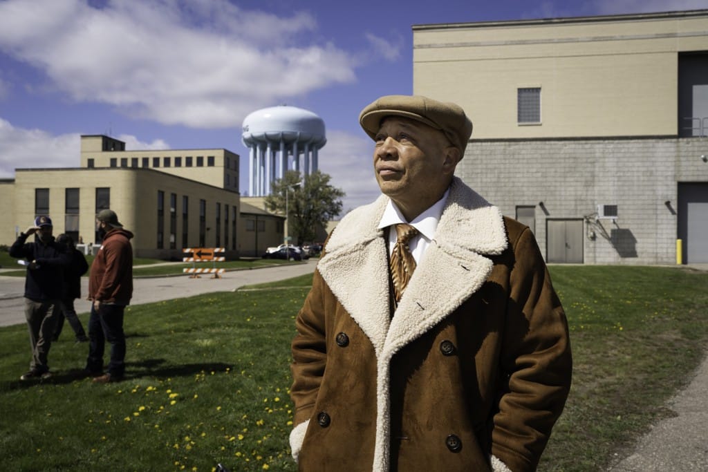 A man in a hat looks toward the sky