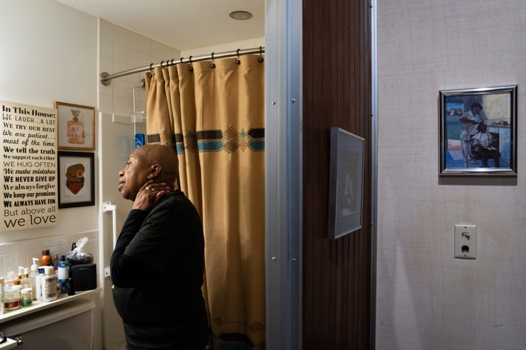 A woman looks into the mirror in the bathroom