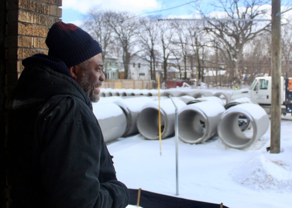 Gerald Patton, Jefferson Chalmers resident, looks at construction outside his home.