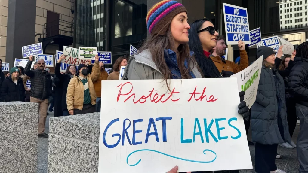 Woman holds "Protect the Great Lakes" sign.