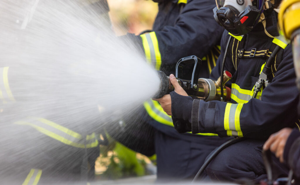 Firefighter spraying water
