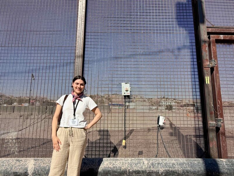 Planet Detroit reporter Isabelle Tavares stands at the U.S.-Mexico border.