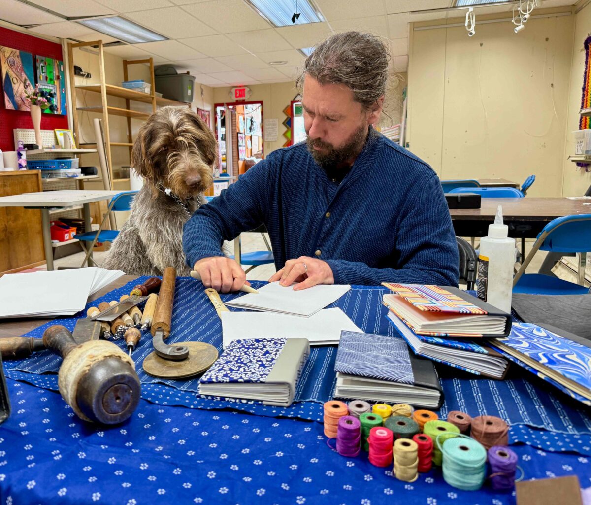 Detroit bookmaker James Griffioen at Arts & Scraps with his dog, Robin.