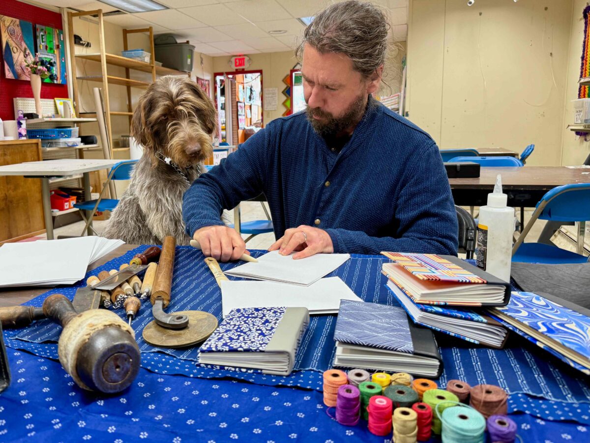 Detroit bookmaker James Griffioen at Arts & Scraps with his dog, Robin.