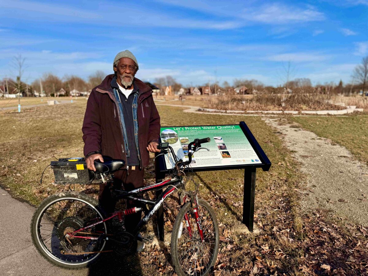 Danny Dolley stands with his bicycle in Chandler Park on Detroit's east side.