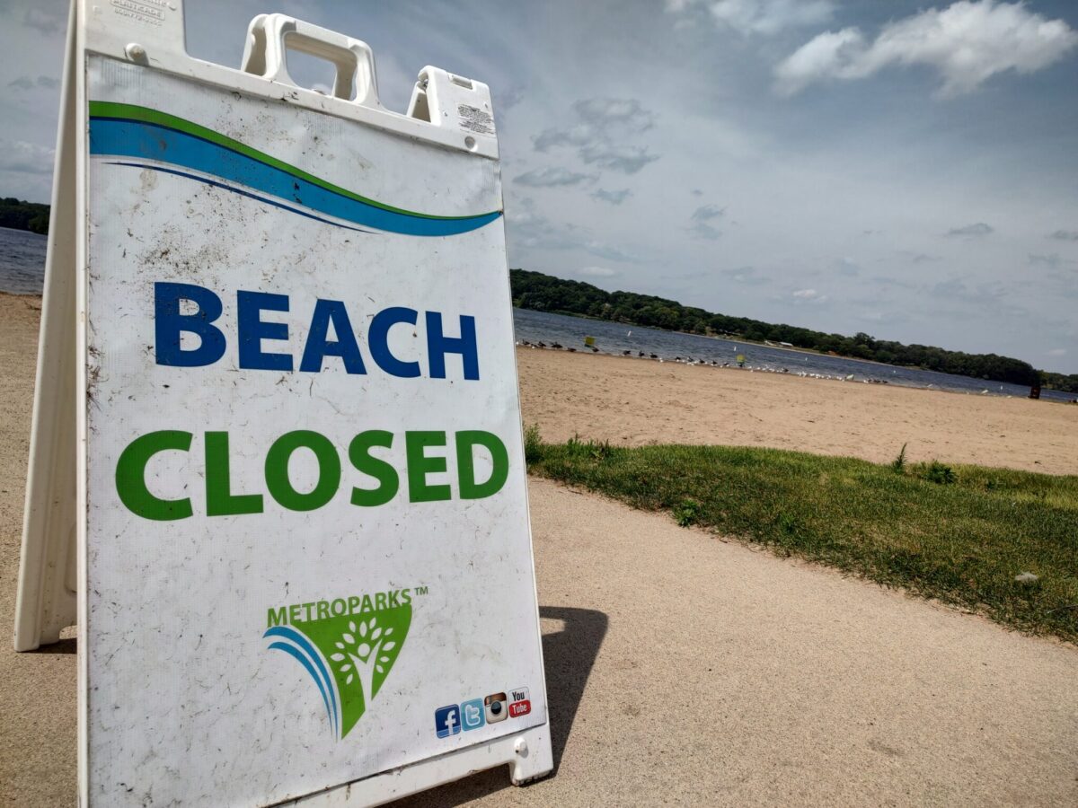 Martindale Beach at Kensington Metropark sits empty as signs announce the beach is closed due to potential hexavalent chromium contamination.