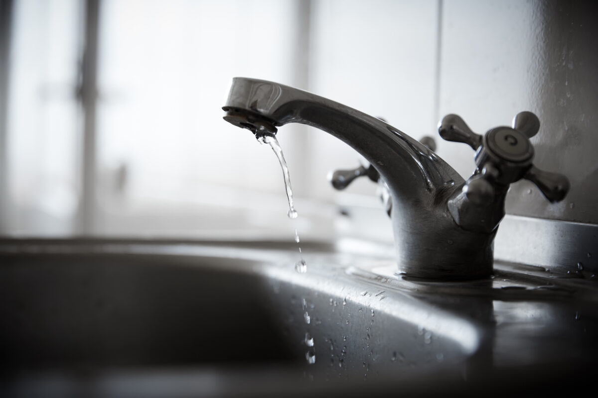 Drinking water drips from faucet.