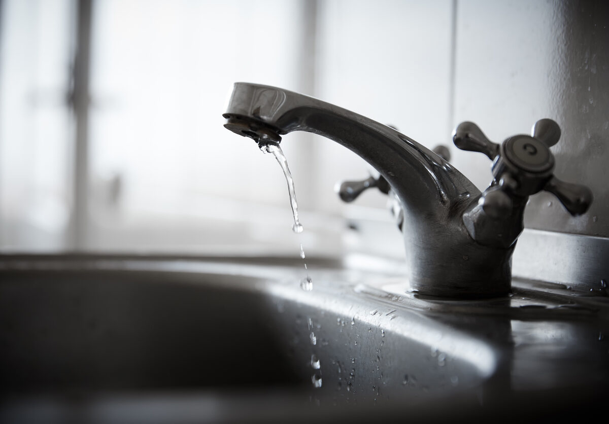 Drinking water drips from faucet.