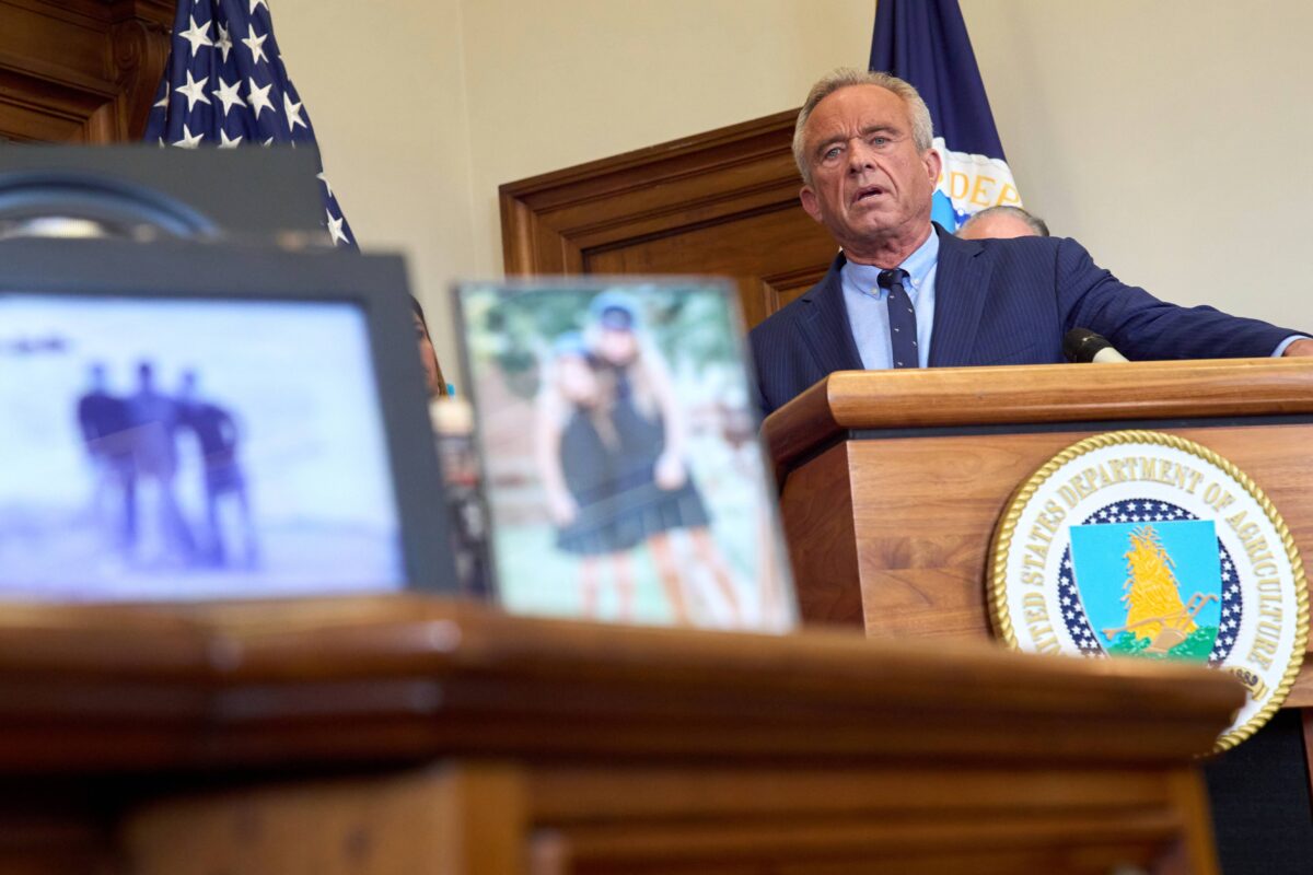 Secretary of Health and Human Services Robert F. Kennedy Jr. speaks from a podium at a press conference.