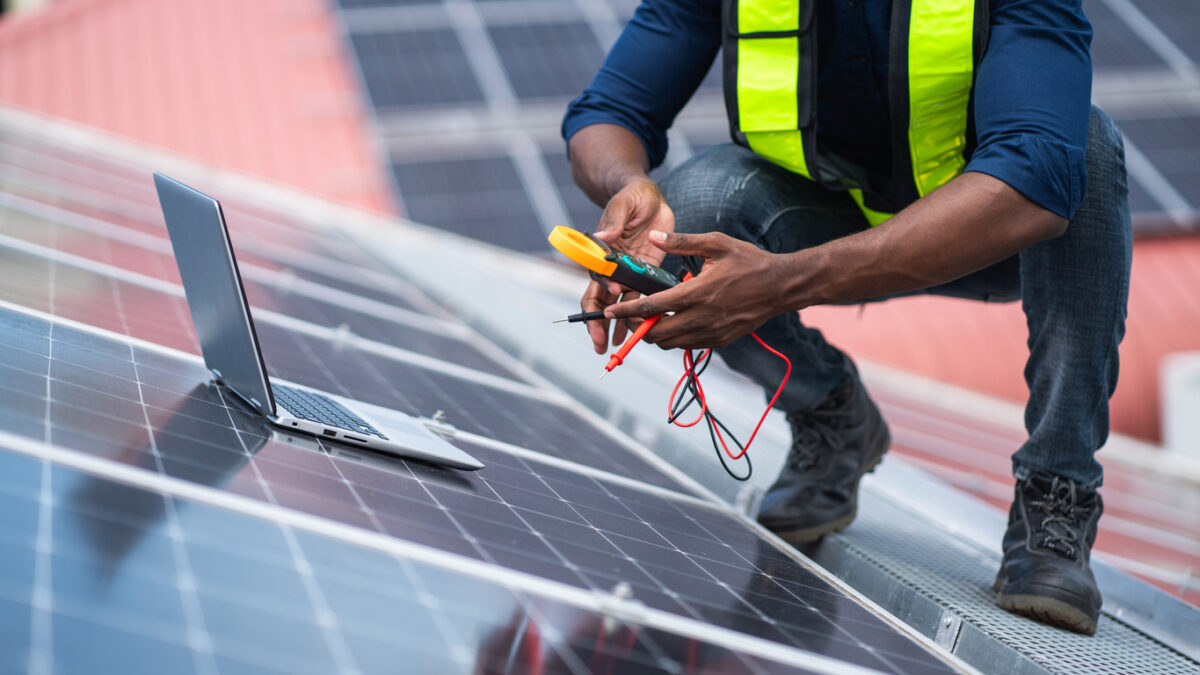 A worker checks a solar panel