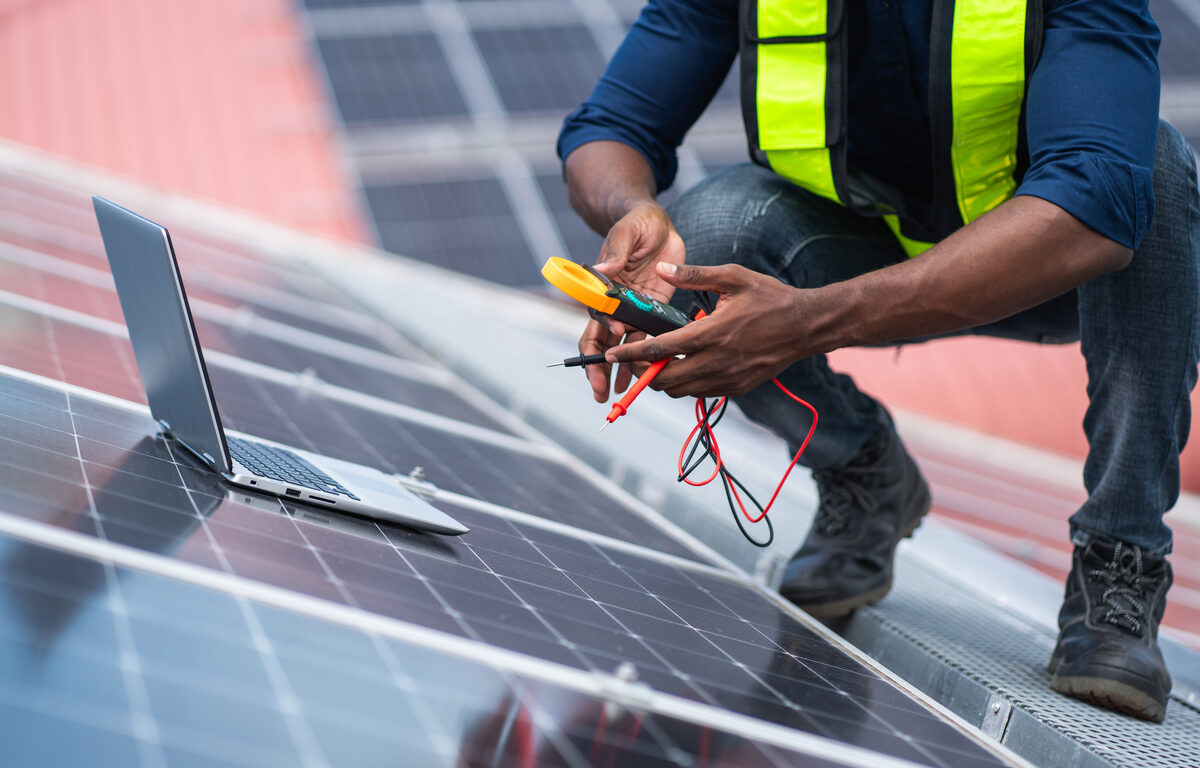 A worker checks a solar panel