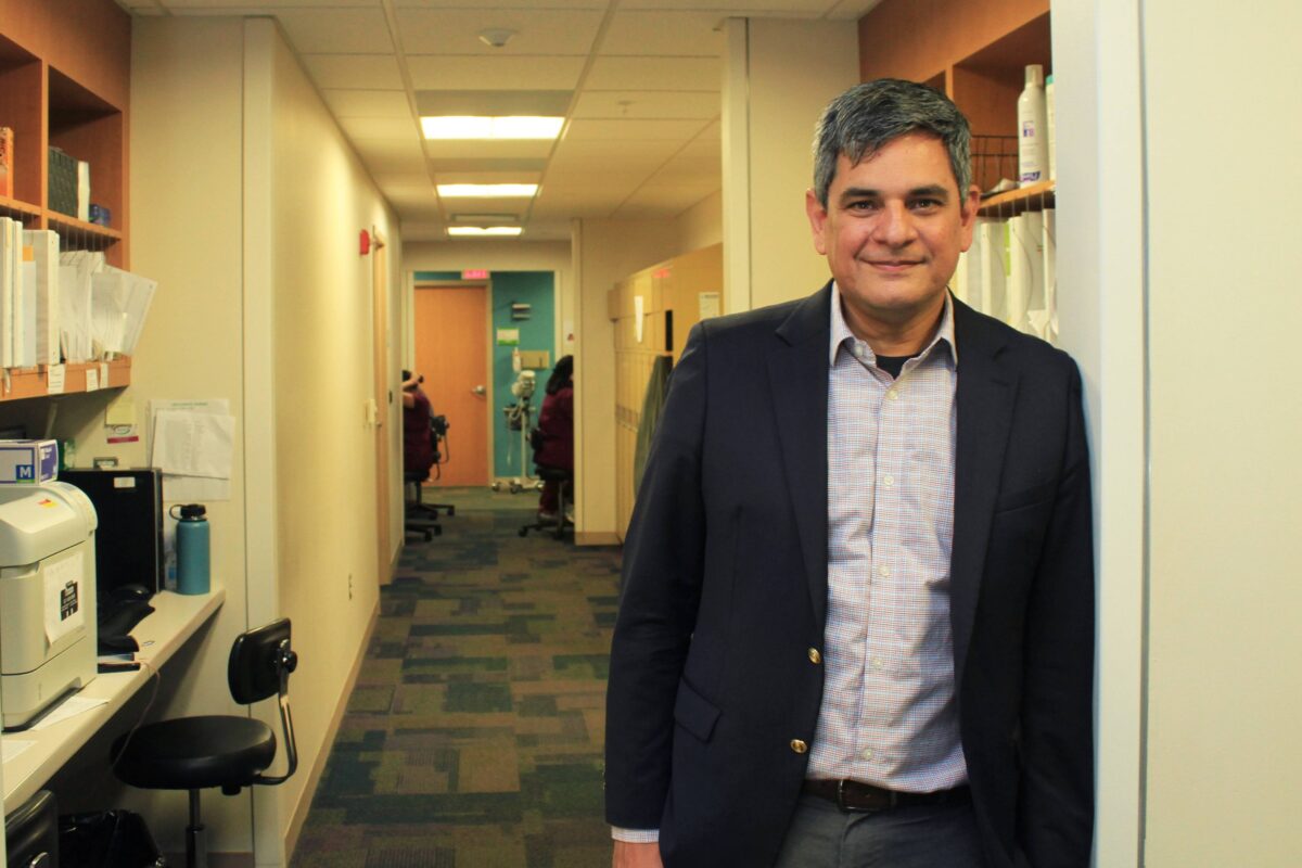 Dr. Felix M. Valbuena, Jr., CEO of Detroit's Community Health and Social Services Center, stands in a hallway.