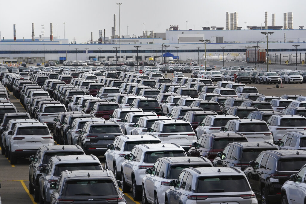 New vehicles are shown parked in storage lots near the the Stellantis Detroit Assembly Complex.