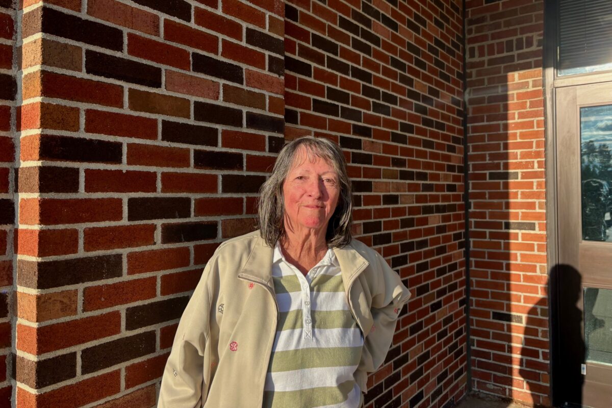 Augusta Township resident Dale-Lin Mallonen stands against a brick wall outside the municipal offices.