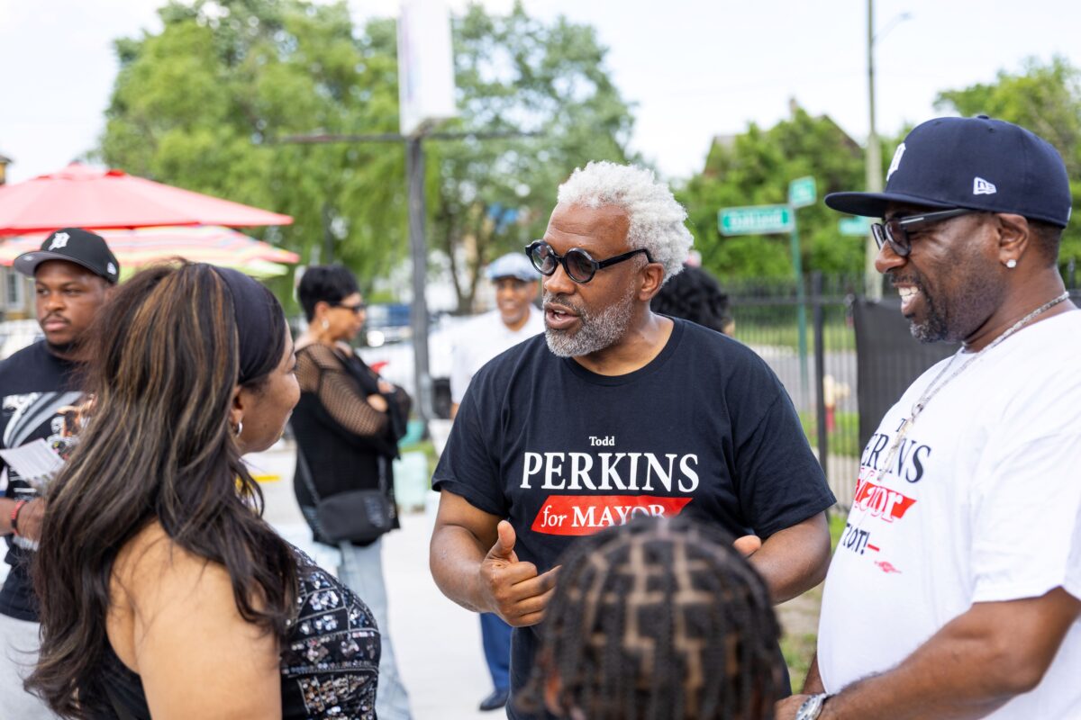 Attorney Todd Perkins speaks with residents while campaigning for Detroit mayor.