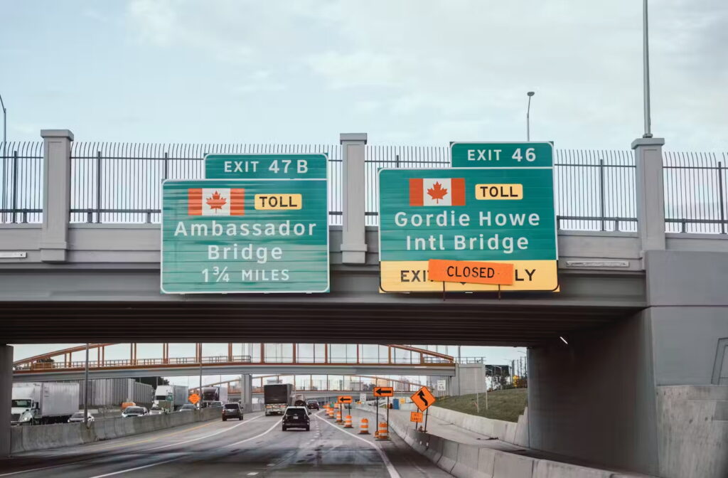 Freeway signs for the Ambassador Bridge and soon-to-open Gordie Howe International Bridge.