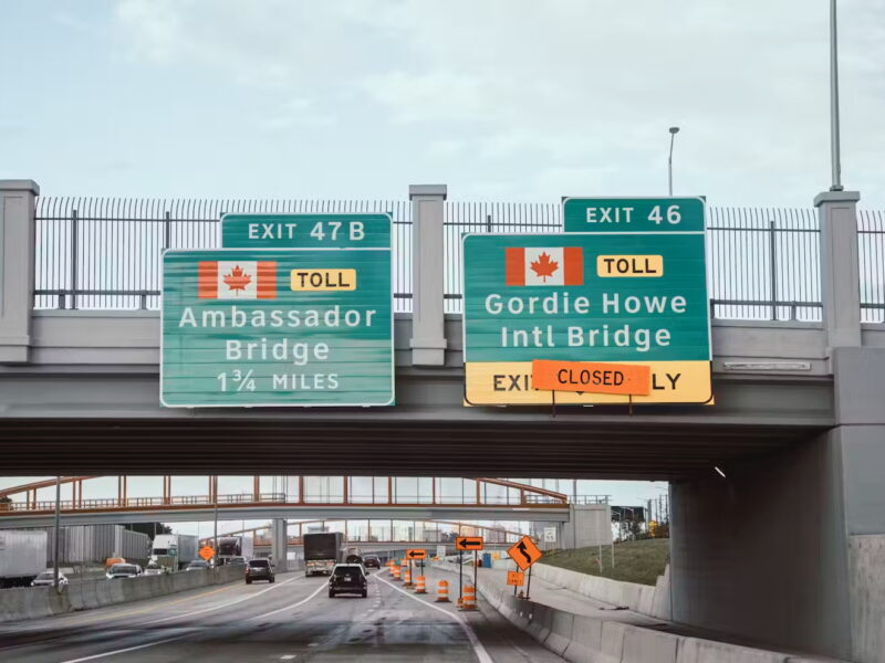 Freeway signs for the Ambassador Bridge and soon-to-open Gordie Howe International Bridge.
