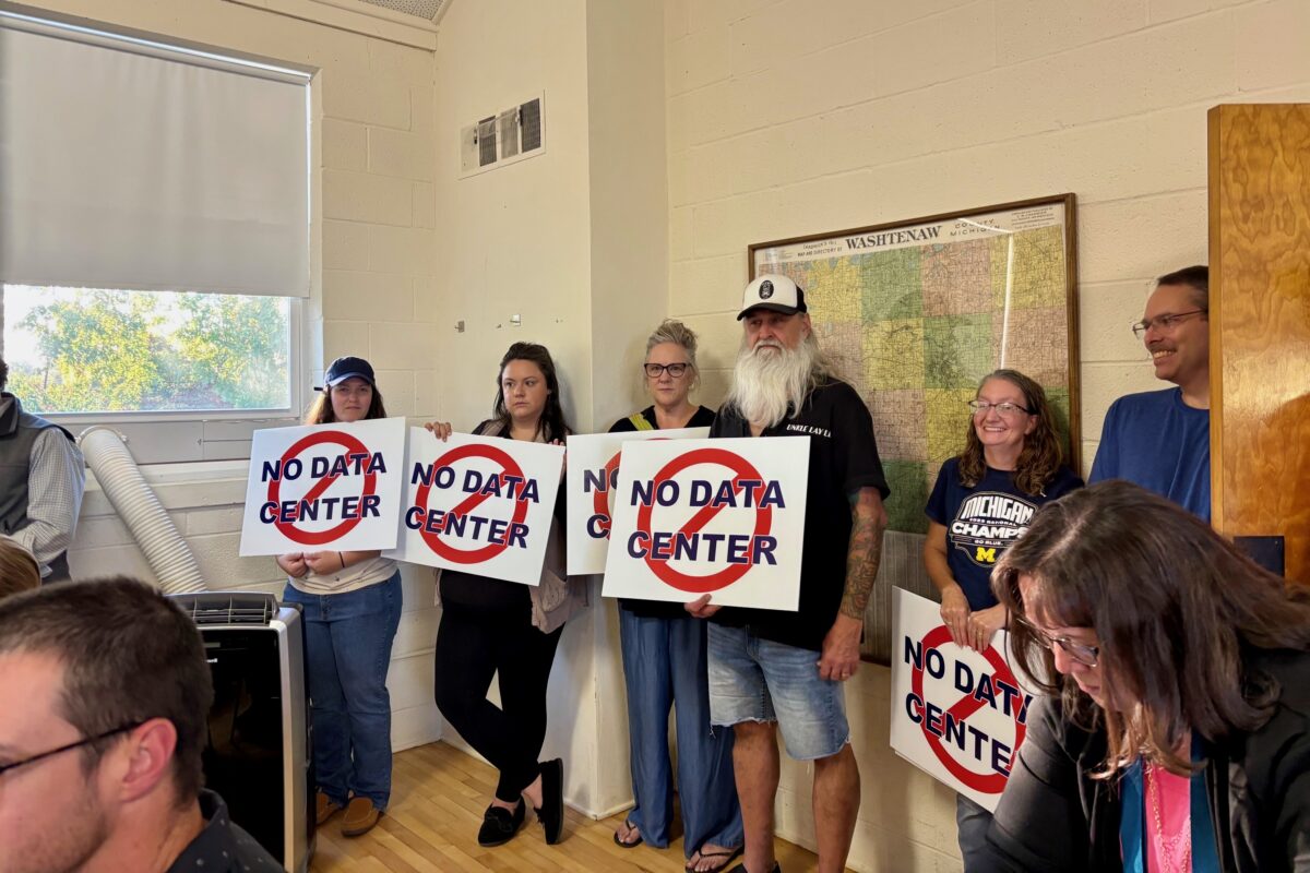 Saline Township residents hold "No Data Center" signs at a Sept. 10 township board meeting.