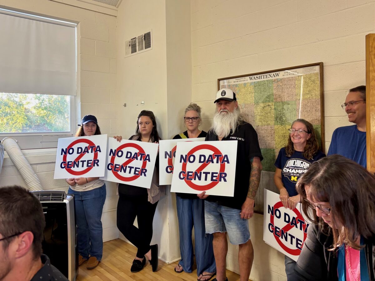 Saline Township residents hold "No Data Center" signs at a Sept. 10 township board meeting.