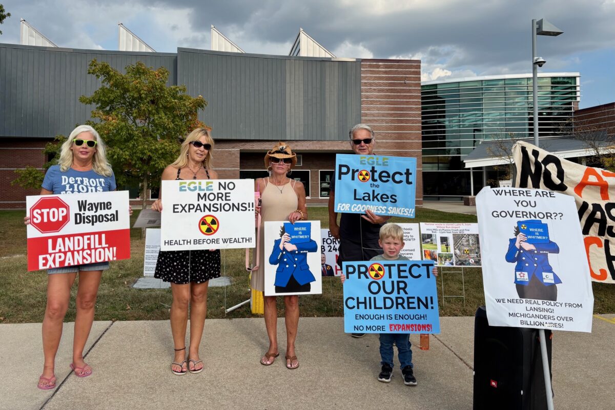 Demonstrators hold signs outside a hearing on the expansion of the Wayne Disposal hazardous waste facility.