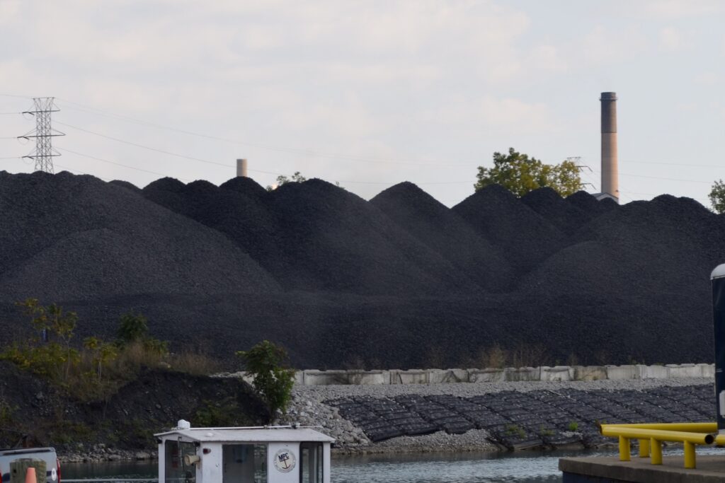 Piles of coal or a similar byproduct or substance are visible on Zug Island, seen from West Jefferson Avenue in Detroit.