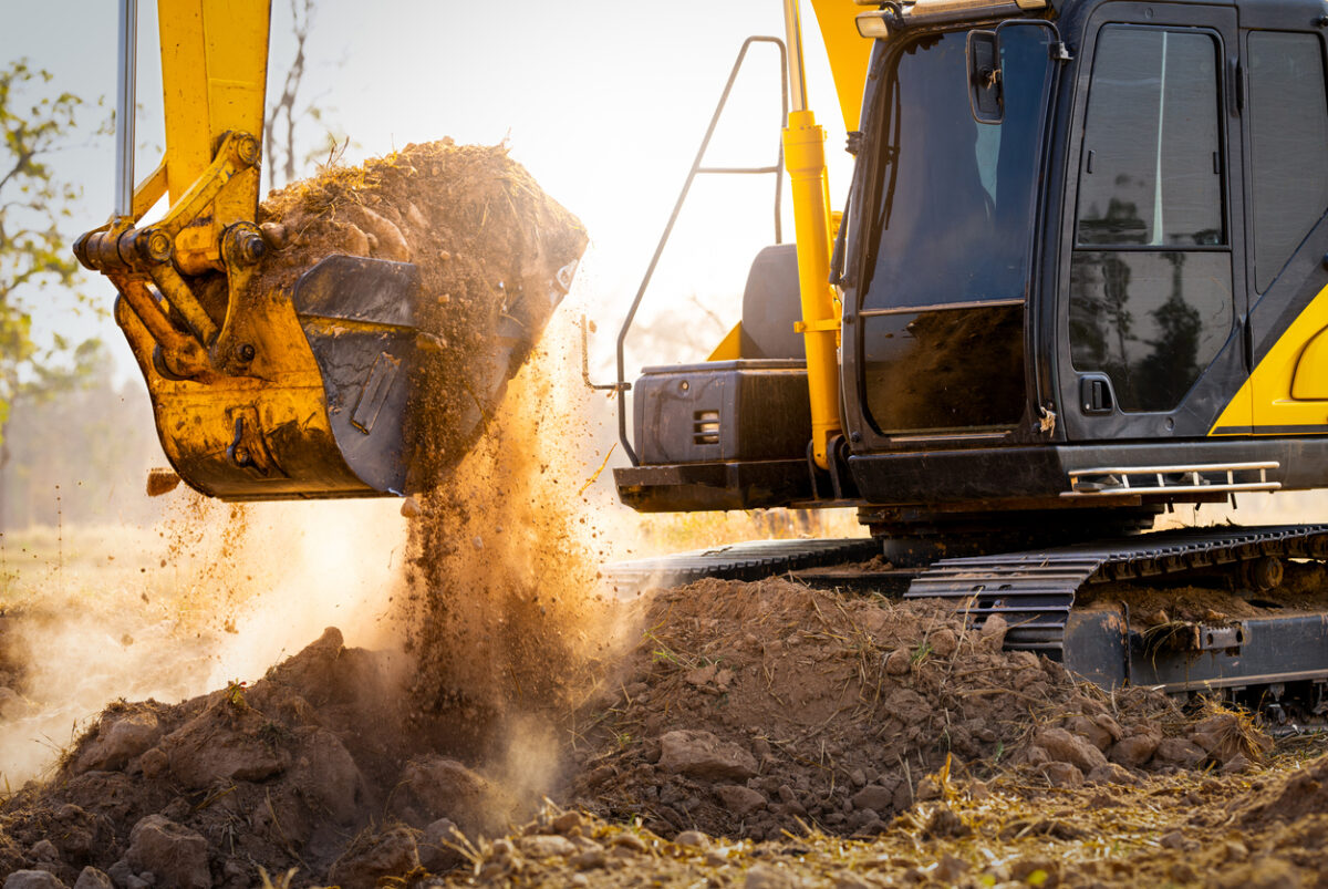 Backhoe moves dirt at construction site