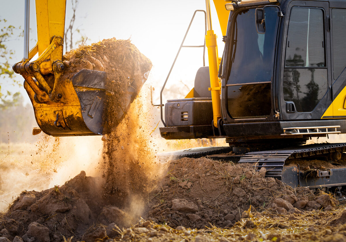 Backhoe moves dirt at construction site