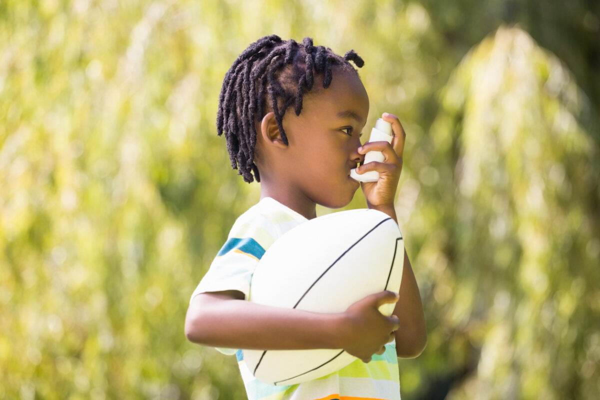 Child using an asthma inhaler.