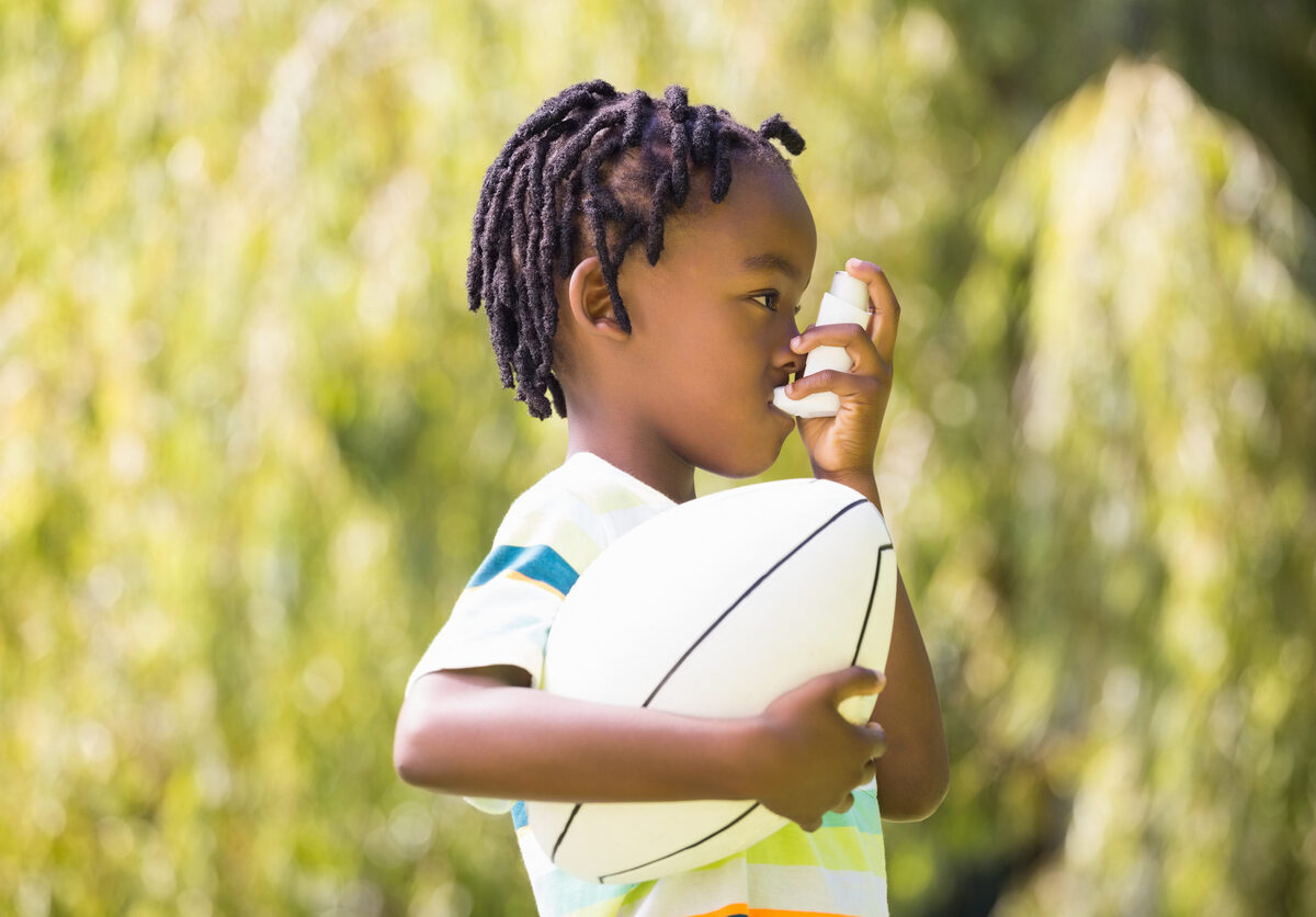 Child using an asthma inhaler.