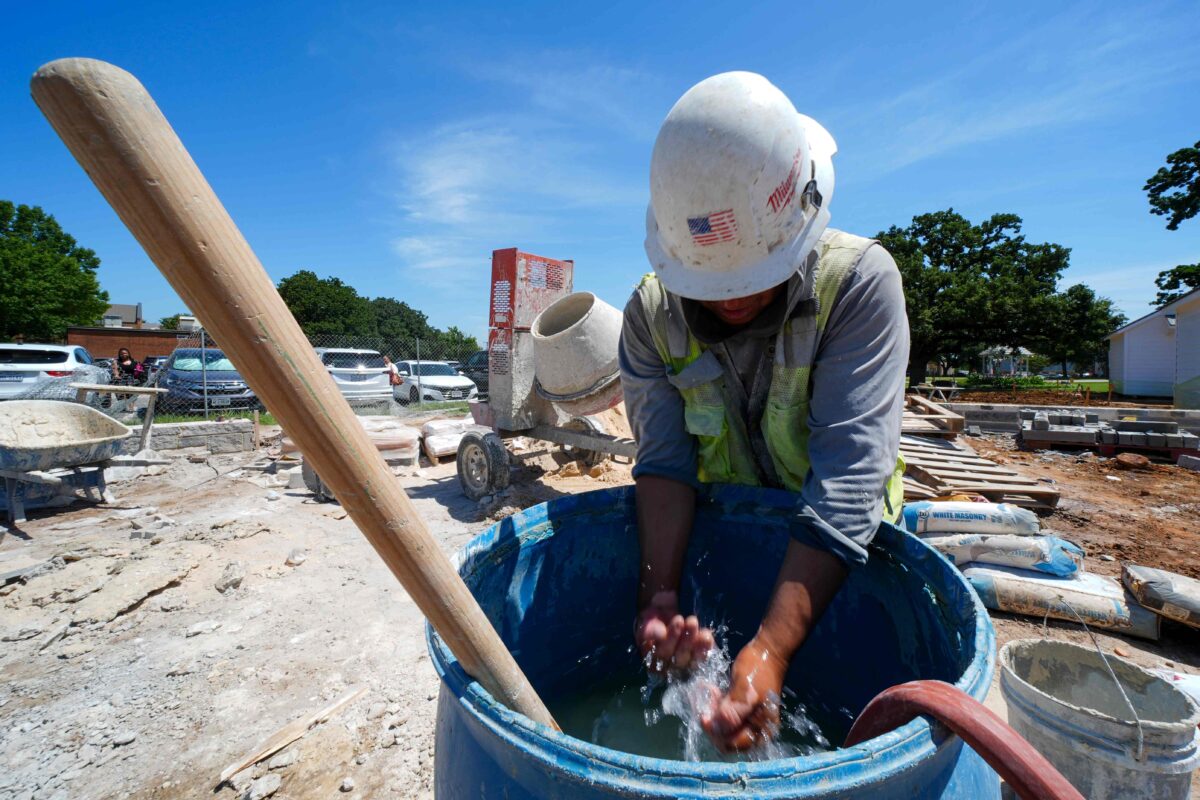 Construction worker Justino cools off while laboring on a foundatio