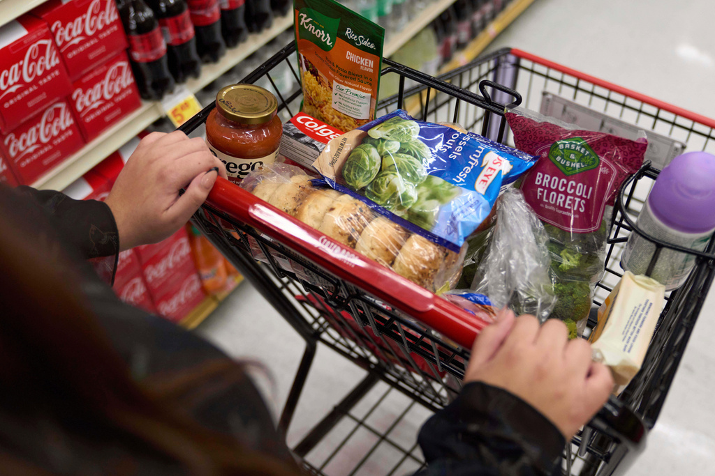 A California's SNAP benefits shopper pushes a cart through a supermarket in Bellflower, Calif.