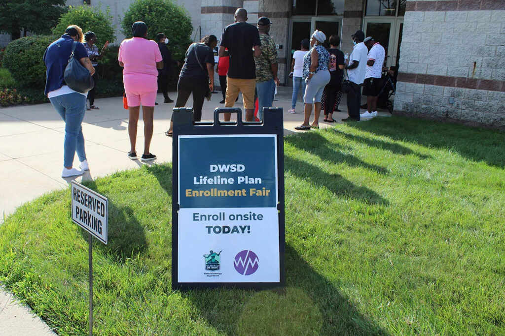 Residents wait for the opening of an enrollment event for the City of Detroit's Lifeline Plan in 2022.