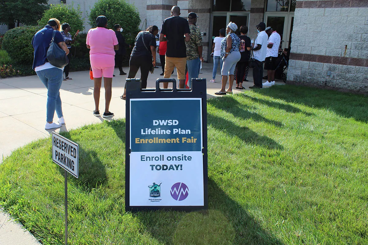 Residents wait for the opening of an enrollment event for the City of Detroit's Lifeline Plan in 2022.