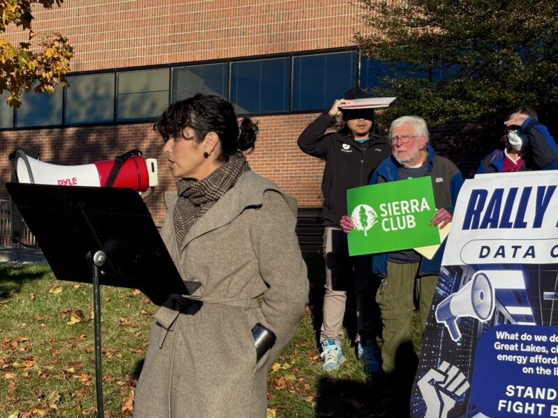 Michelle Martinez, director of the University of Michigan’s Tishman Center for Social Justice and the Environment, speaks into a bullhorn.