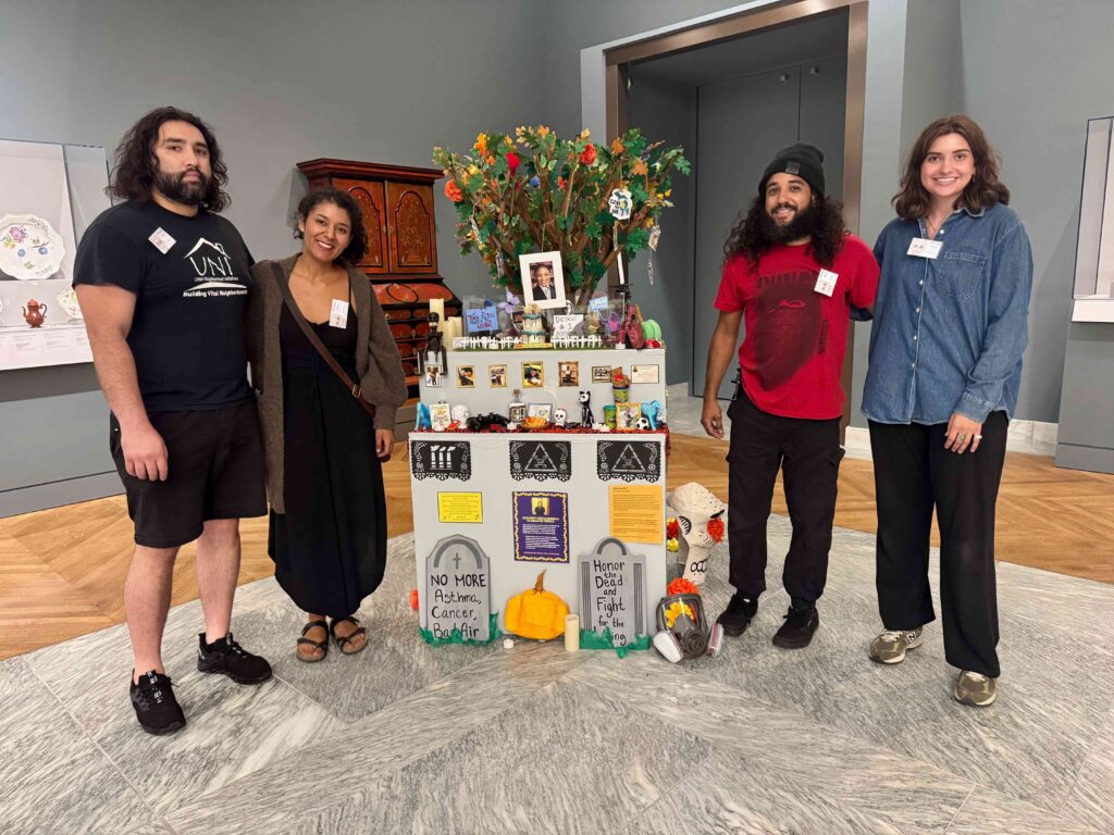 Artists and organizers stand with the ofrenda at the Detroit Institute of Arts.