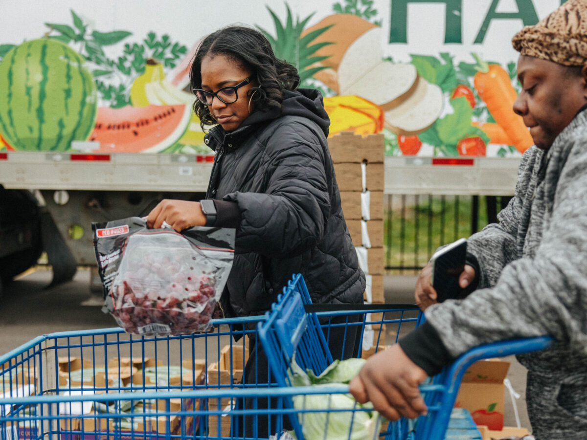 Volunteers distribute food at a mobile pantry at Jesus Tabernacle of Deliverance Ministries on Detroit's east side.