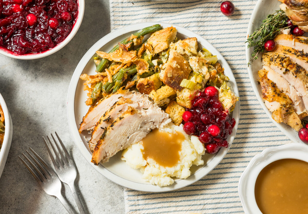 A Thanksgiving turkey dinner plate with potatoes and cranberries.
