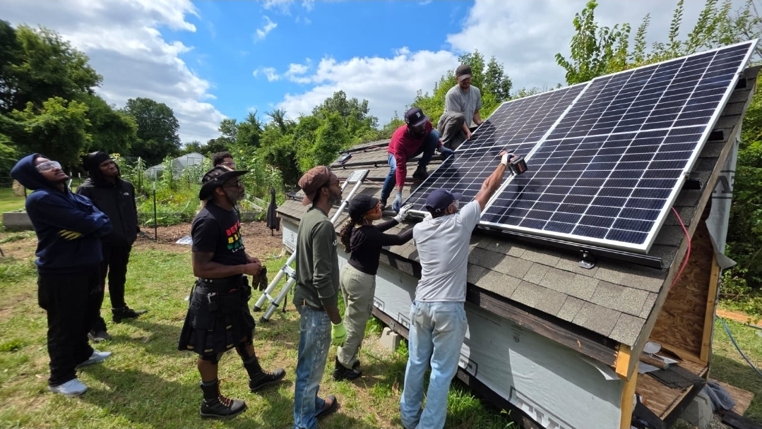 Students at Detroit's Solar Intelligence Training Academy work with solar panels.