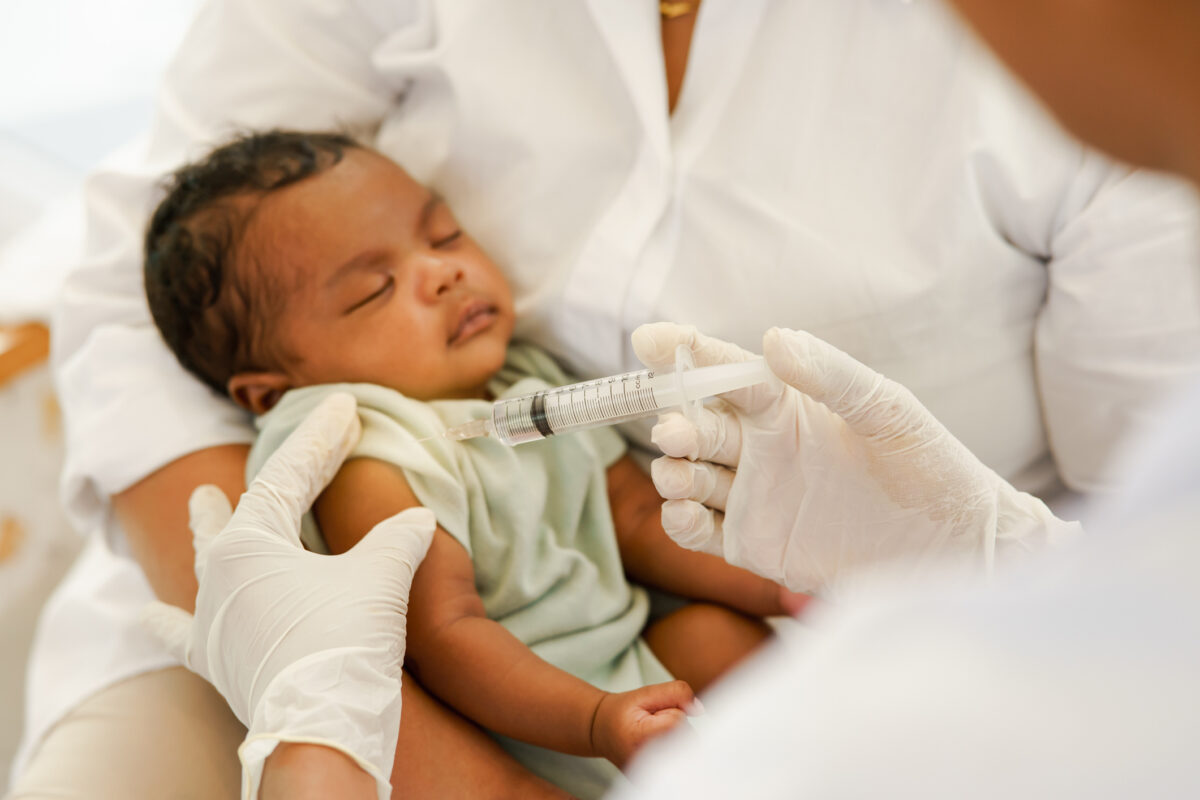 Newborn baby receiving a vaccine