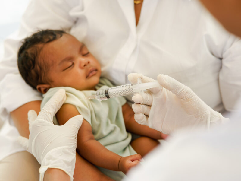 Newborn baby receiving a vaccine