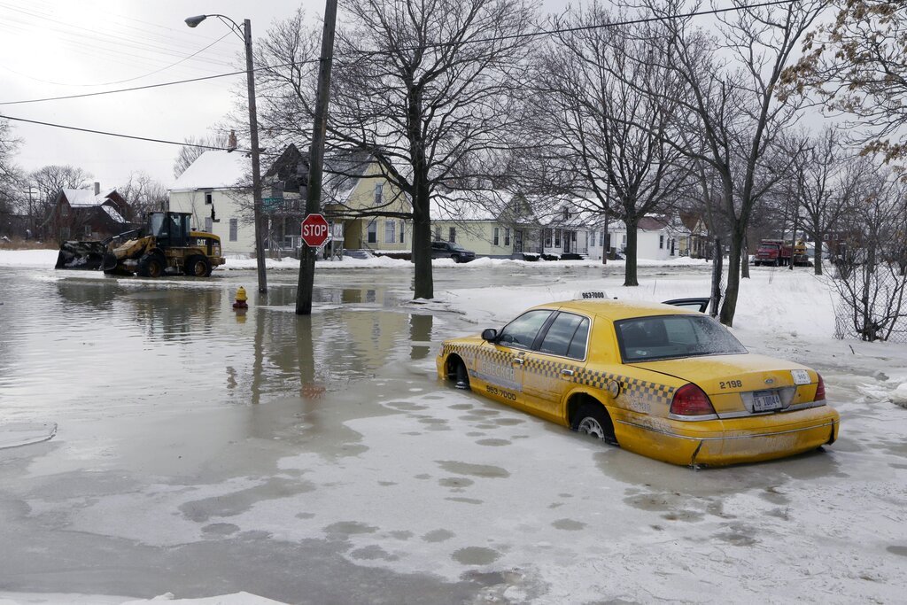 A taxi cab is surrounded by water on a flooded street after a water main break flooded several blocks in Detroit in 2014.