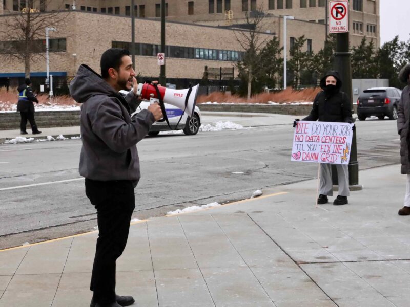 U.S. Senate candidate Abdul El-Sayed in Detroit speaks into a megaphone near DTE Energy headquarters on Dec. 3.