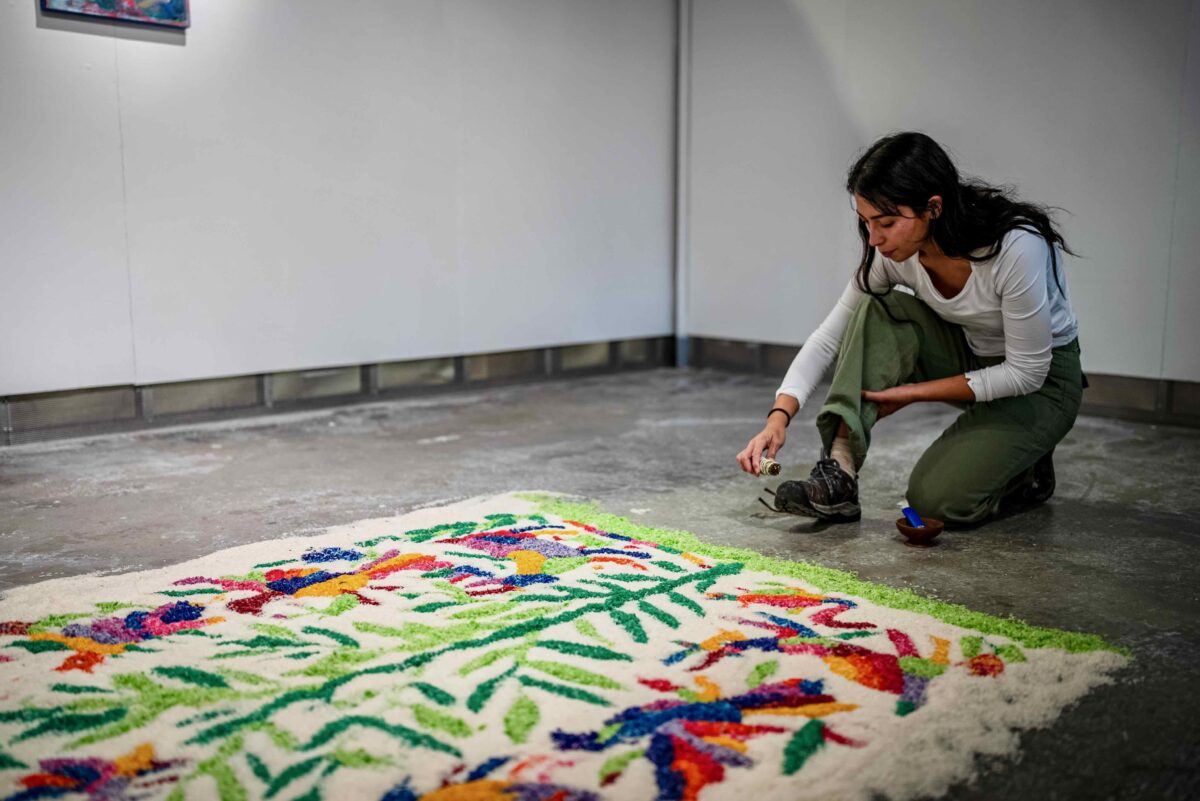 Julianna Sanromán works on a colorful piece