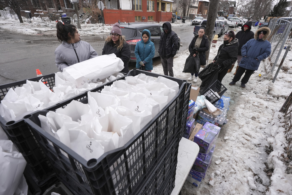 Neighbors stand in line for supplies being given away after a water main break in Southwest Detroit in February 2025.