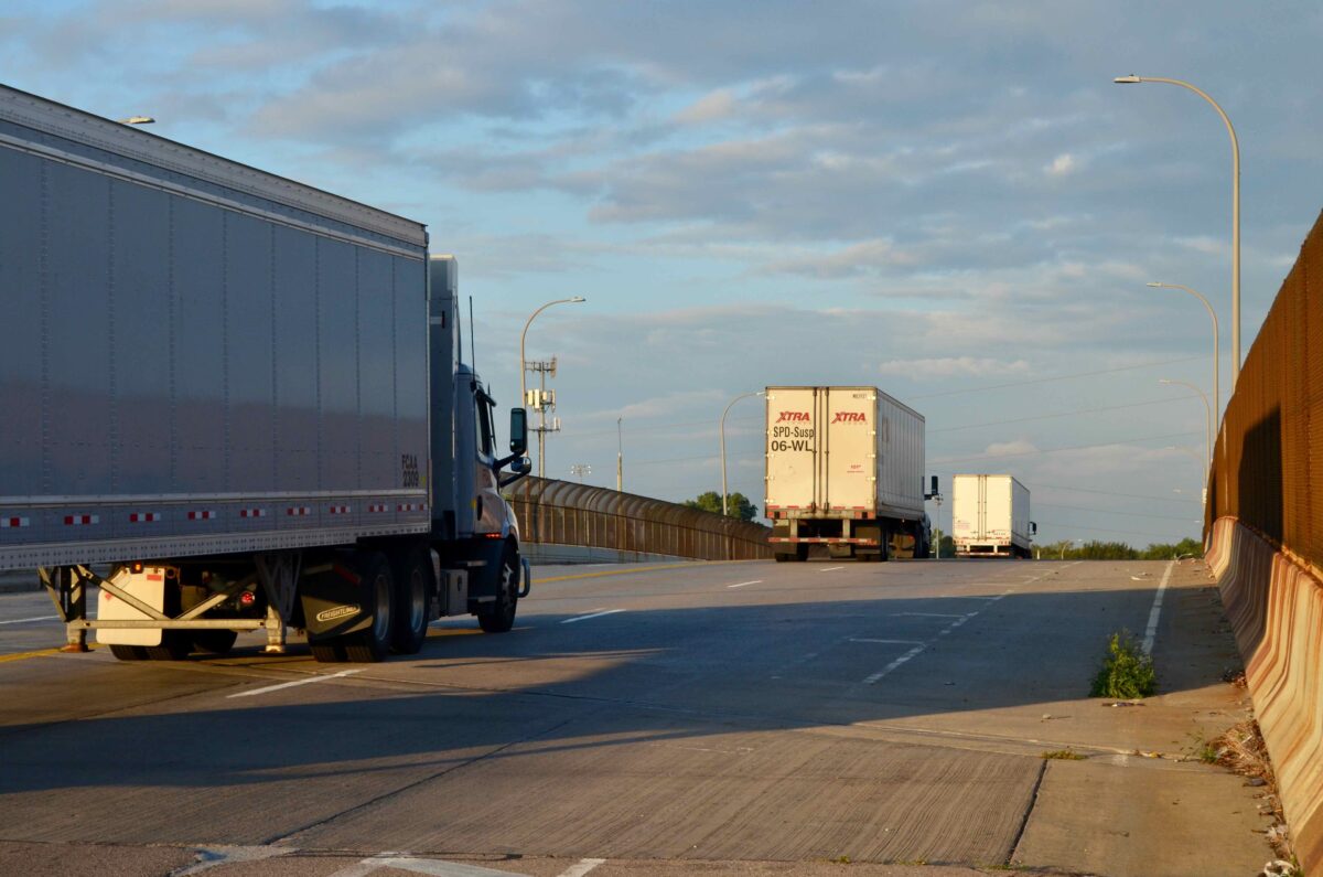 Semis travel on Mack Avenue near the Stellantis plant on Detroit's east side.