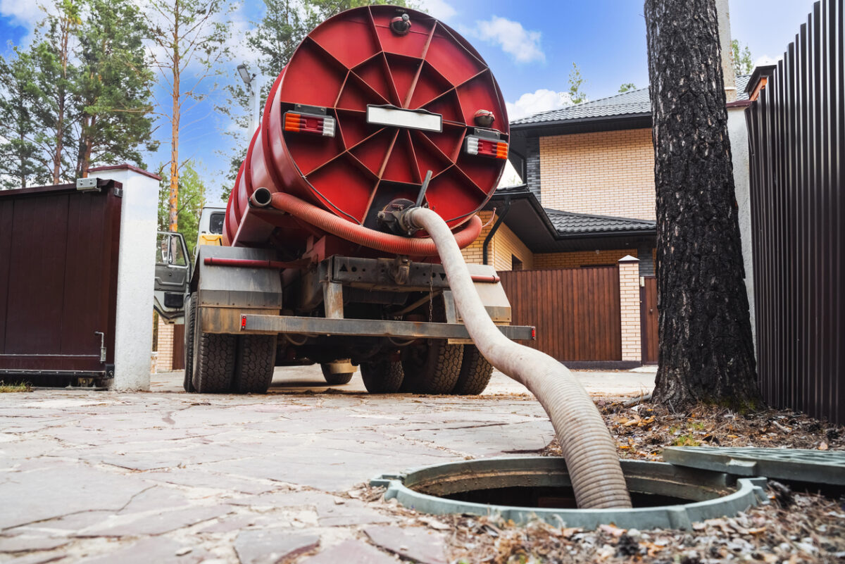 A truck pumps out sewage from a septic tank.