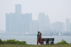 Shahrukh Ahmed and Hibah Khan pose on Belle Isle as haze from Canadian wildfire smoke blankets Detroit and creates poor air quality.