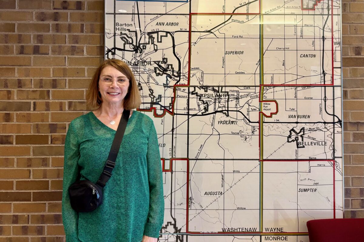 Augusta Township resident Wendy Albers stands in front of a map of Washtenaw County outside a YCUA meeting.