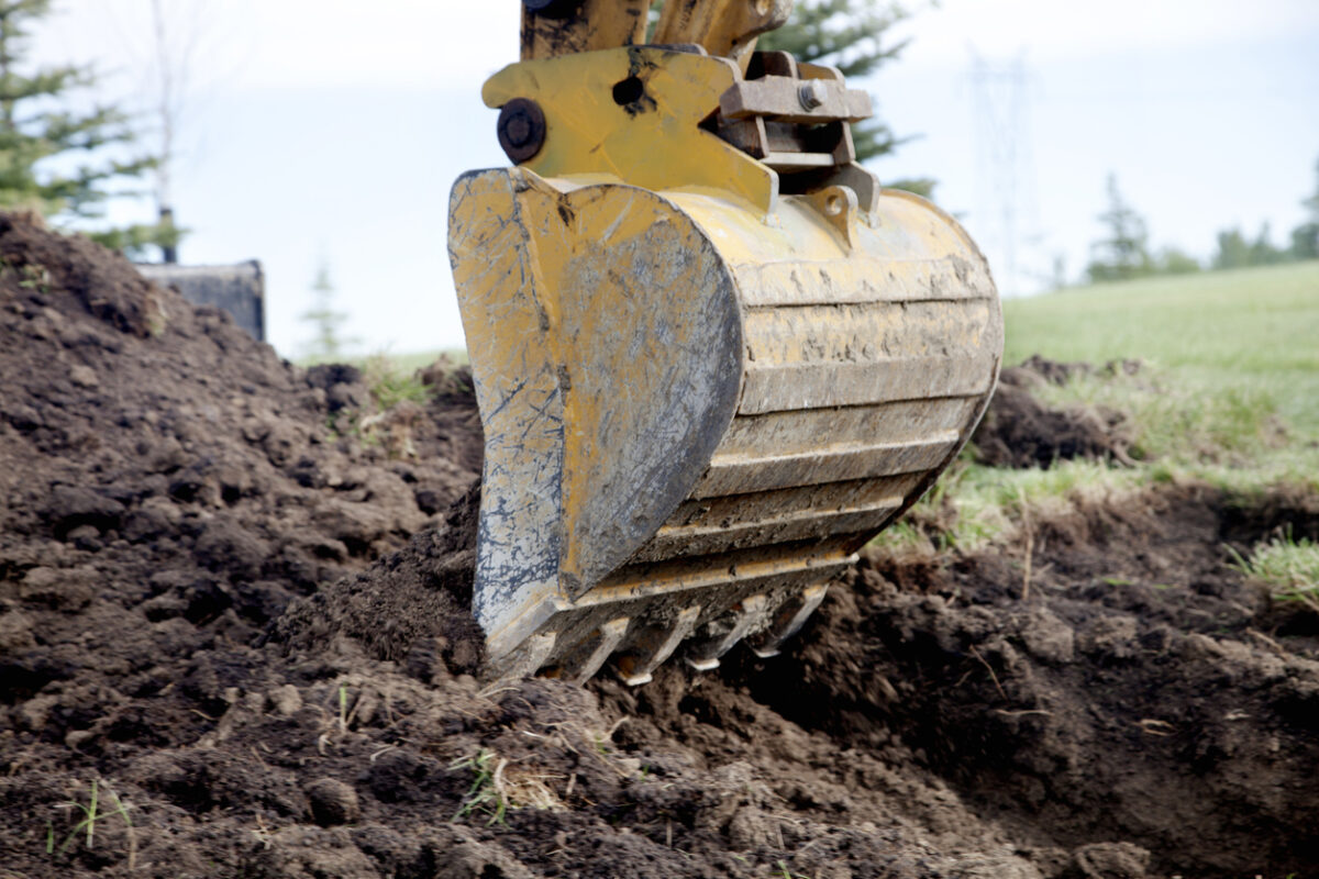 A backhoe and pile of dirt